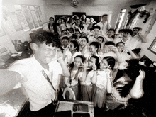 a black and white photo of a group of people with a man wearing a lanyard that says ' sds '
