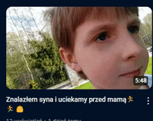 a screenshot of a child 's face with the time 5:48