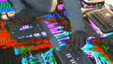 a person is playing a keyboard with a multicolored background