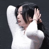 a woman in a white sweater with the word no way on the bottom right