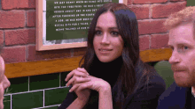 a woman sitting in front of a sign that says " we met sonny when he came into social "