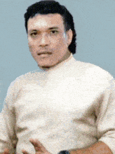 a man wearing a white shirt is making a funny face