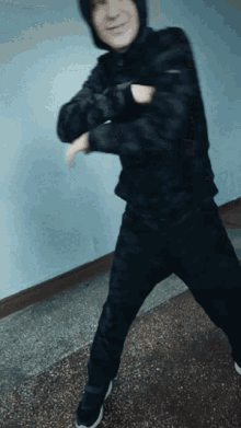 a blurry picture of a man in a hooded jacket dancing