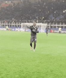 a soccer player wearing a number 10 jersey is dancing on the field