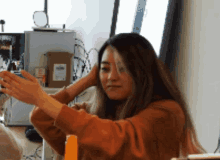 a woman is taking a selfie with her phone