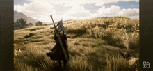 a person holding a sword in a field with a playstation logo on the bottom