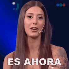 a woman with long hair says es ahora in spanish