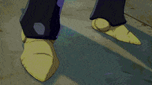 a close up of a person 's feet with a yellow shoe