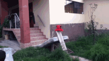 a house with stairs leading up to it and a red light on the side