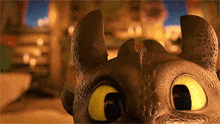 toothless from how to train your dragon is looking at the camera with his big yellow eyes .