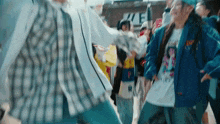 a group of people are dancing in front of a sign that says ' we ' on it .