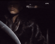 a woman giving the middle finger in a car