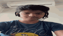 a young man wearing headphones and a shirt that says ' abercrombie ' on it