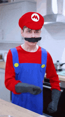 a man dressed in a mario costume with a fake mustache