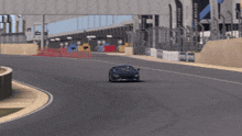 a car is driving down a race track with a sign that says mirage in the background