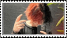a woman with red hair is taking a picture of herself in a picture frame .
