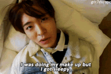 a young man laying on a bed says i was doing my makeup but i got sleepy