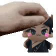 a hand is putting a stuffed doll on top of a stuffed doll .
