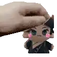 a hand is putting a stuffed doll on top of a stuffed doll .