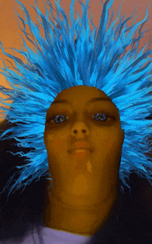 a woman with blue hair and blue eyes looks at the camera