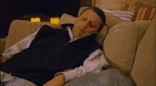 a man sleeping on a couch with his eyes closed