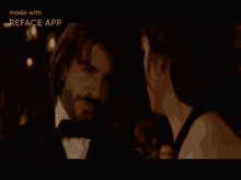 a man in a tuxedo and a woman in a black dress are looking at each other