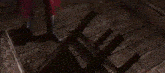 a close up of a video game character holding a sword in front of a brick wall .