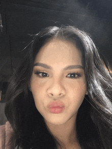 a close up of a woman 's face making a face