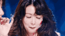 a close up of a woman 's face with rhinestones on it