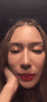 a close up of a woman 's face with red lipstick on