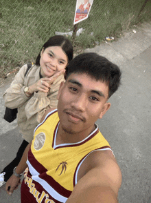 a man wearing a jersey that says ' hawks ' on it poses with a woman