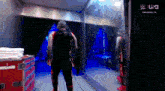 a wrestler is standing in front of a mirror in a room with a sign that says usa on it
