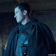 a man in a cape is standing in a dark room and the caption says joequingifs