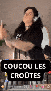 a woman wearing headphones is dancing in front of a mirror with the words coucou les croutes on the bottom