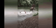 a man with a prosthetic leg is jumping into a river .