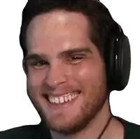 a close up of a man wearing headphones smiling