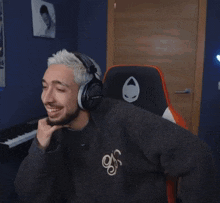 a man wearing headphones and a sweater that says n on it