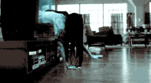 a blurred image of a person standing in a room
