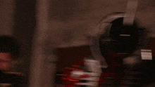 a person in a red and white costume with a glowing light coming out of their hand