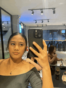 a woman taking a selfie with her phone