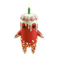 a figurine of a birthday cake with a green candle on top