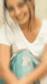 a blurry picture of a pregnant woman with a blue pillow on her belly