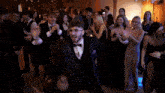 a group of people are dancing at a party