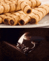 a close up of a plate of wafer rolls next to a picture of a lighter