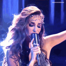 a woman singing into a microphone with the hashtag amahioverdose