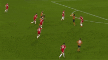 soccer players on a field with ads for click & fit tyres and sky bet