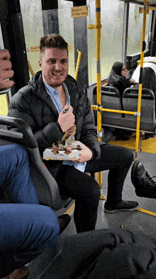 a man is sitting on a bus with a sign on the door that says do not sit on the steps