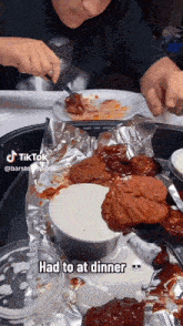 a tiktok video shows a person eating chicken wings