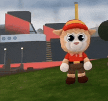 a stuffed animal wearing a red shirt and brown shorts is standing in the grass