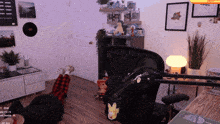 a person laying on the floor in front of a microphone with a pikachu sticker on the back